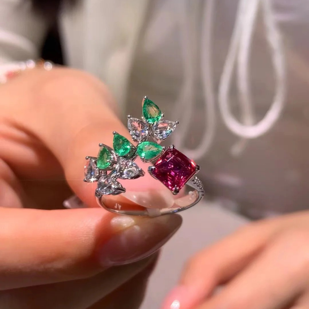 18k gold unheated padparadscha sapphire ring with diamond, emerald, and white topaz inlay