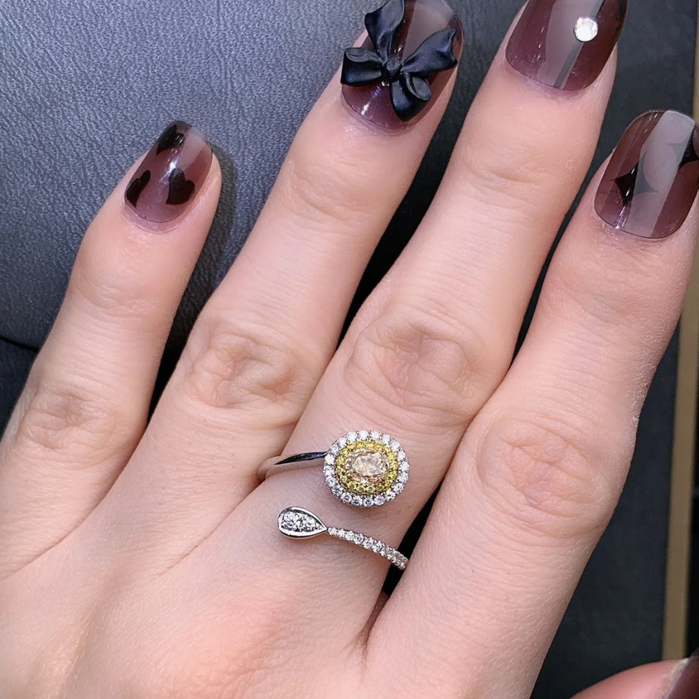 18k yellow diamond ring with oval-cut center stone