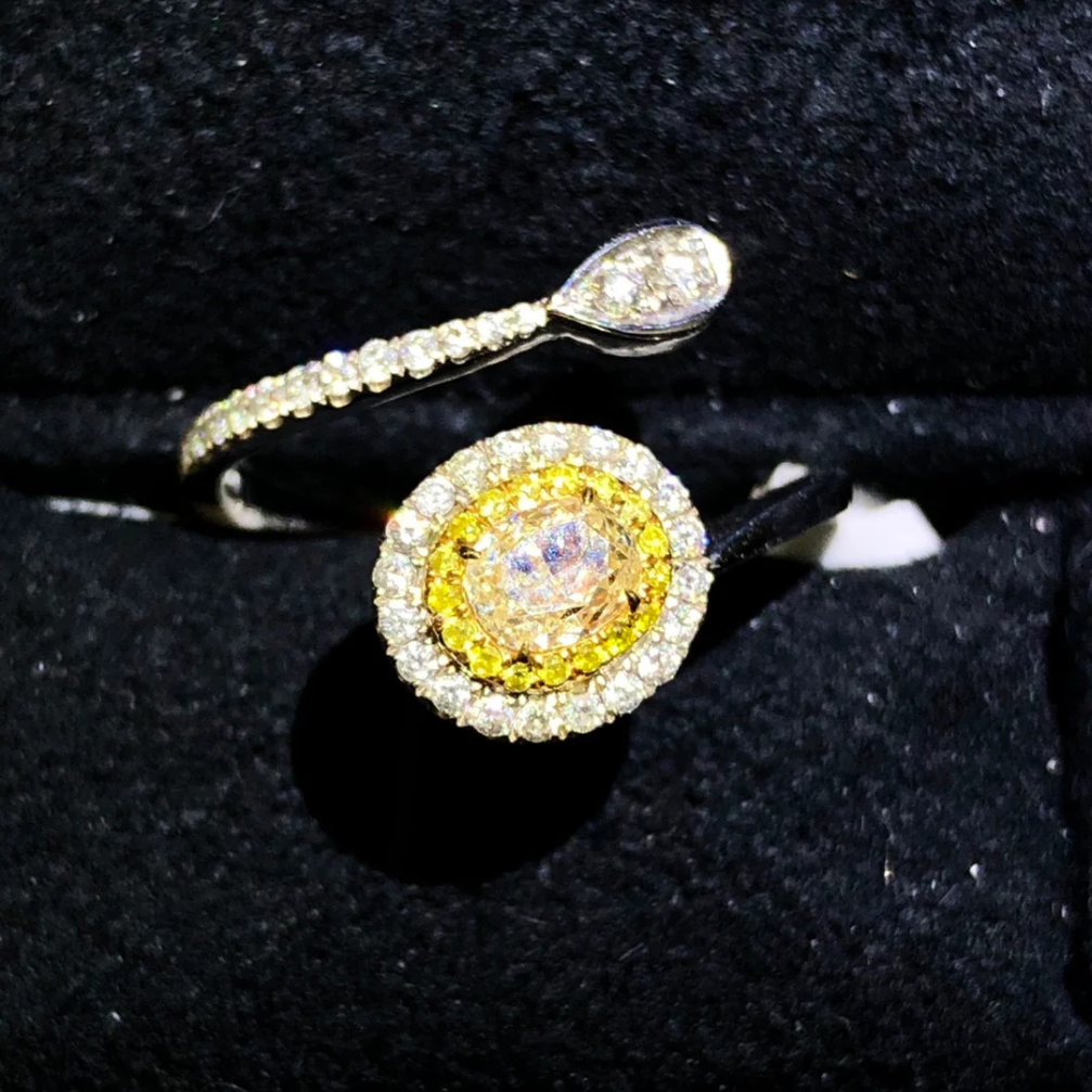 18k yellow diamond ring with oval-cut center stone