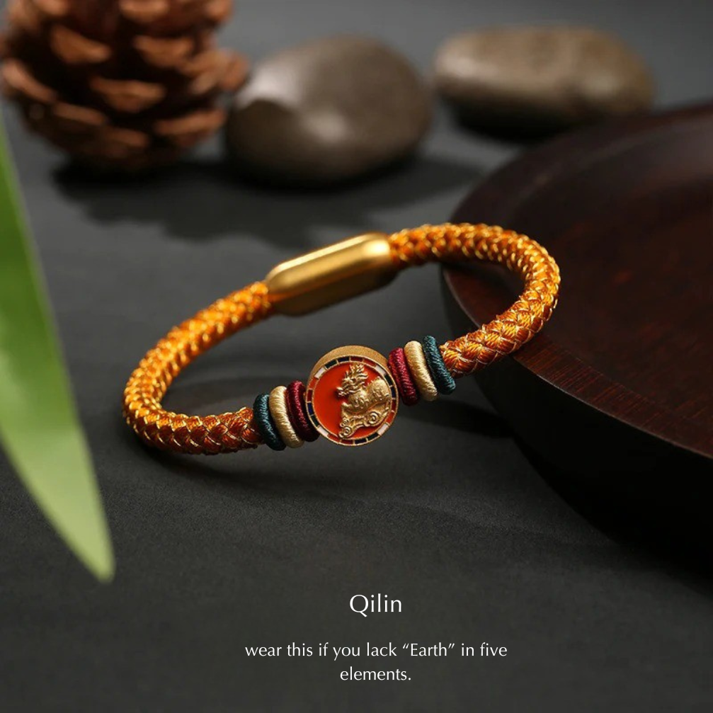 bracelet with gold clasp and colorful beads on a dark surface with qilin