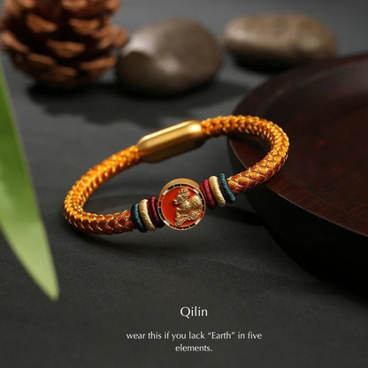 Bracelet with gold clasp and colorful beads on a dark surface with Qilin